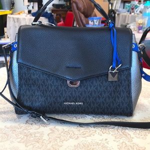 Michael Kors: blue, black, and silver bag.